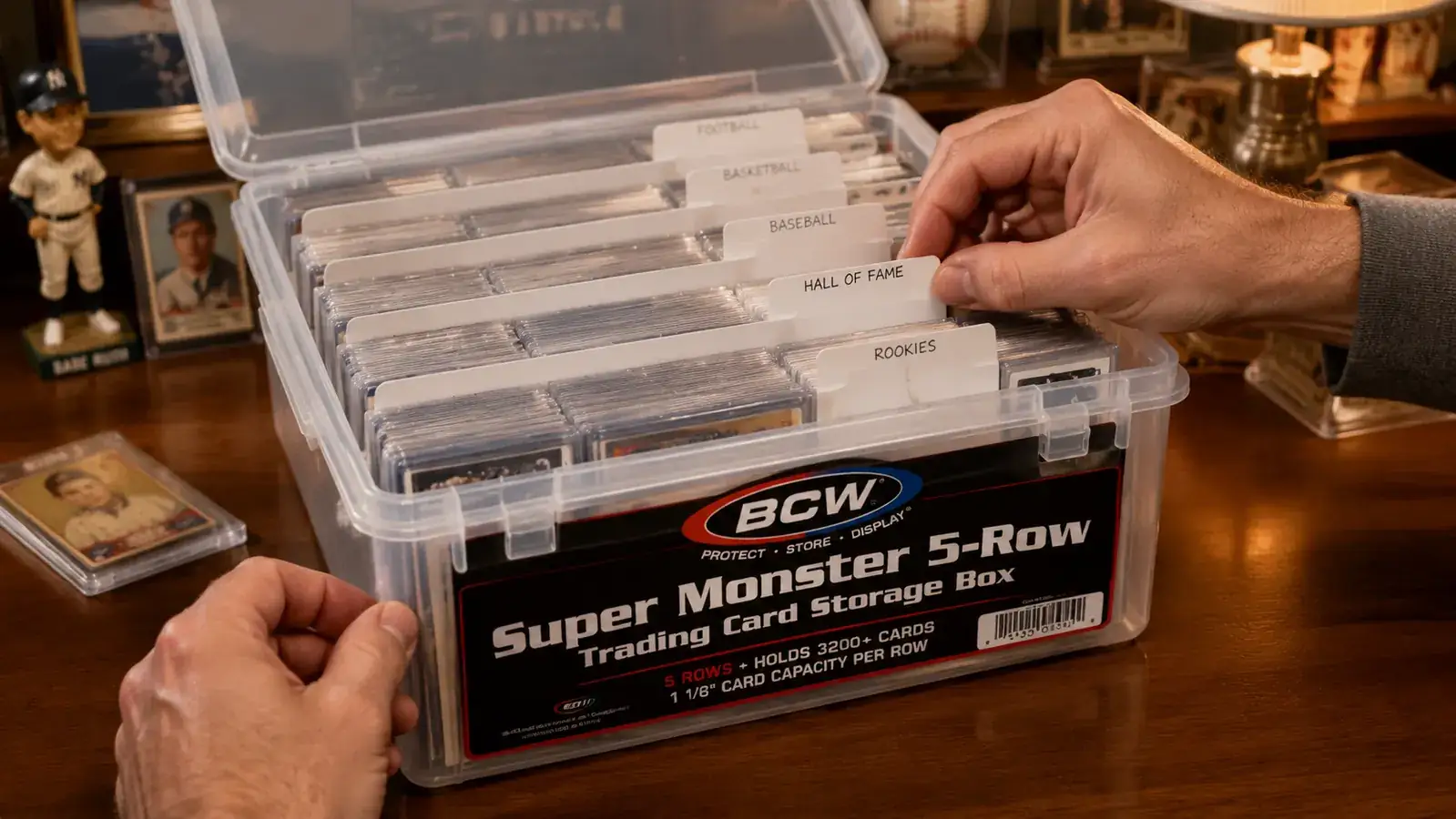 BCW Super Monster storage box open, showing rows of sleeved trading cards sorted with labeled dividers