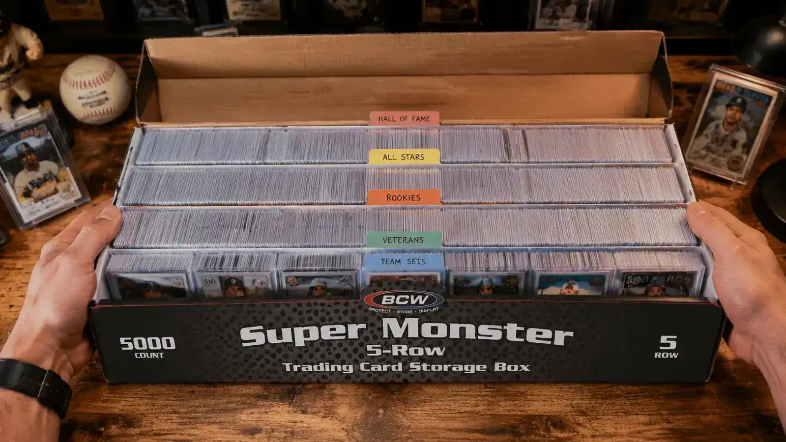 Interior of a BCW Super Monster box showing five rows of sleeved baseball cards organized with labeled dividers