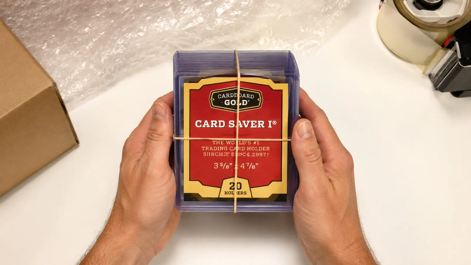 Twenty Card Saver 1 holders bundled with a rubber band ready for a PSA submission shipment